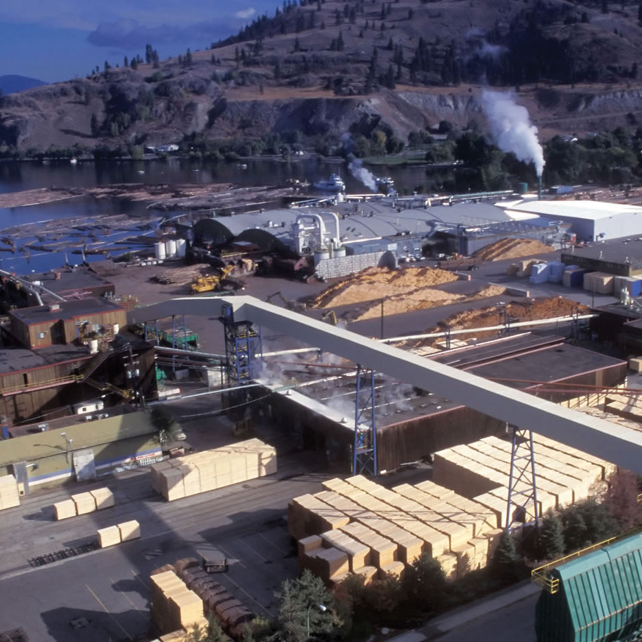 Aerial view of a sawmill by a waterfront